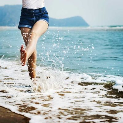 woman jumping in wave